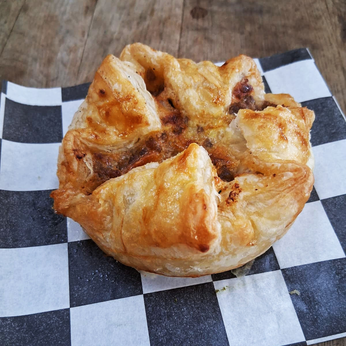 Delicate puff pastry shells cradle a sophisticated filling of tender beef bolognese, fresh mozzarella, and traditional tomato sauce in these elegant Italian pizzettas