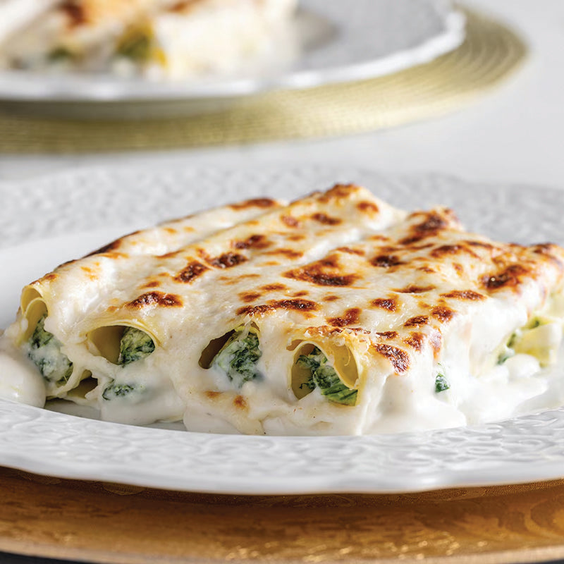 spinach cannelloni on a white plate