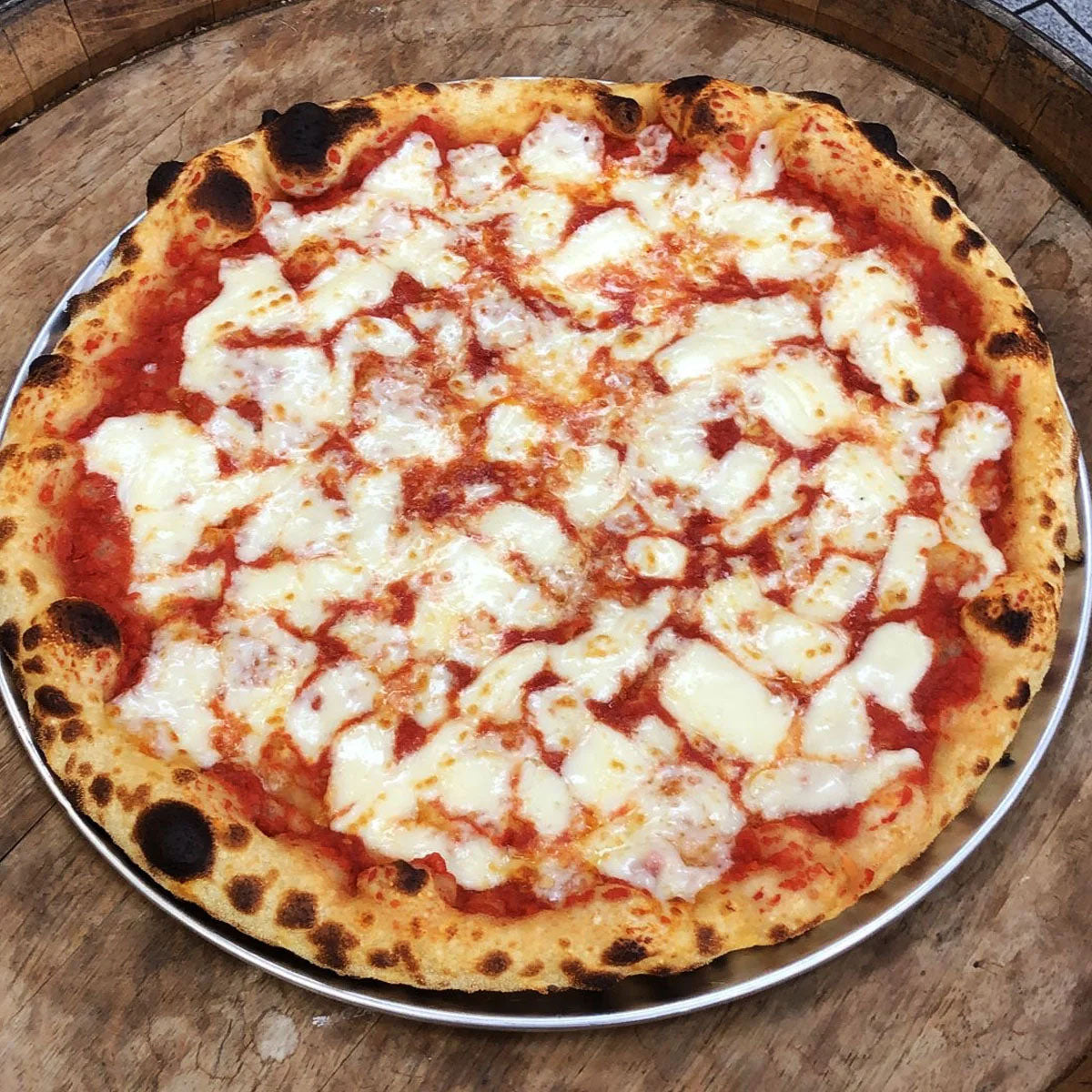 cheese pizza features a perfectly balanced blend of creamy mozzarella and our house-made tomato sauce, spread across a hand-tossed crust. 