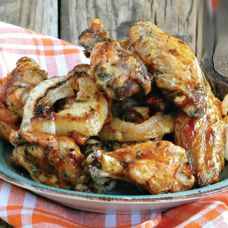 Baked chicken wings with a red and white checkered cloth underneath