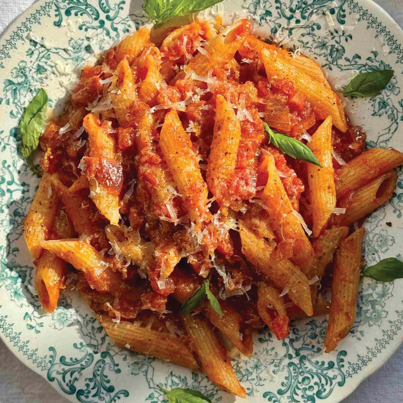 Penne arrabbiata spicy pasta with tomato sauce on a decorative plate