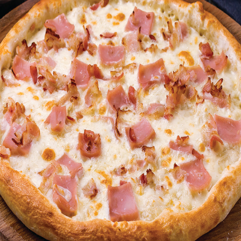 carbonara pizza crafted with creamy mozzarella, aged parmesan, farm-fresh eggs, crispy bacon, and cracked black pepper