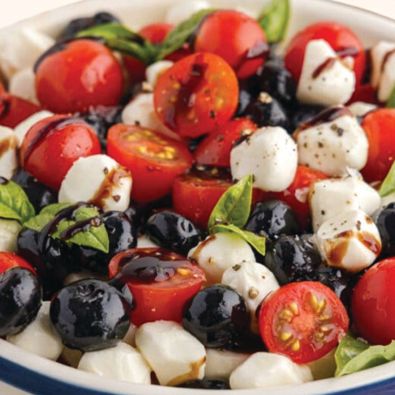 Italian Catering signature with tomatoes, mozzarella, and olives in a bowl